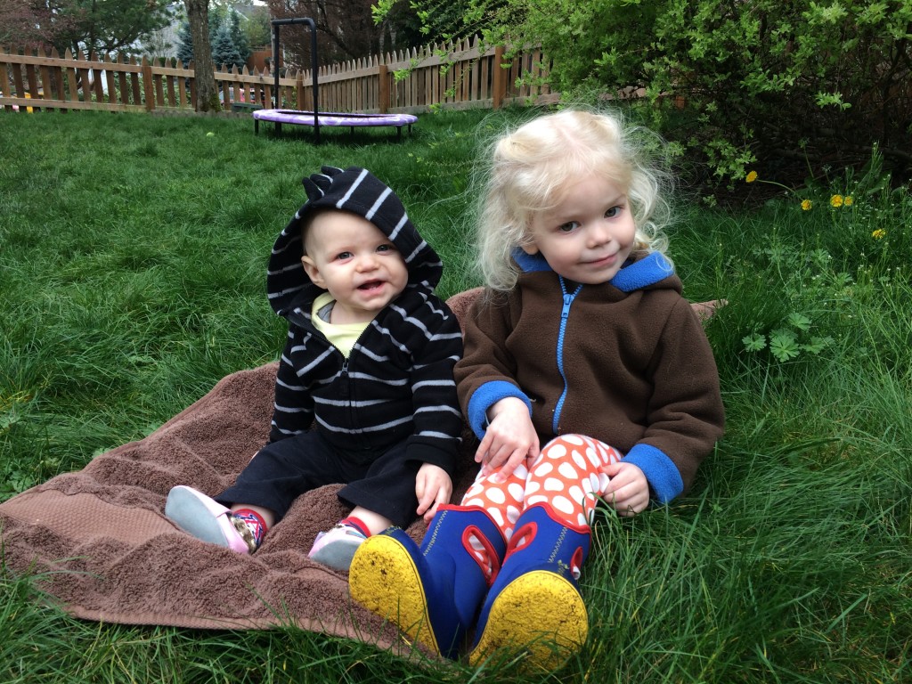 sisters sitting in the grass outside