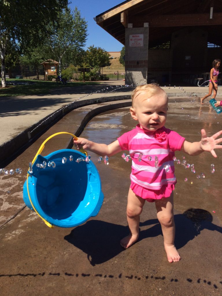 Now that this toddler can walk, she loves the splash pad all summer long!